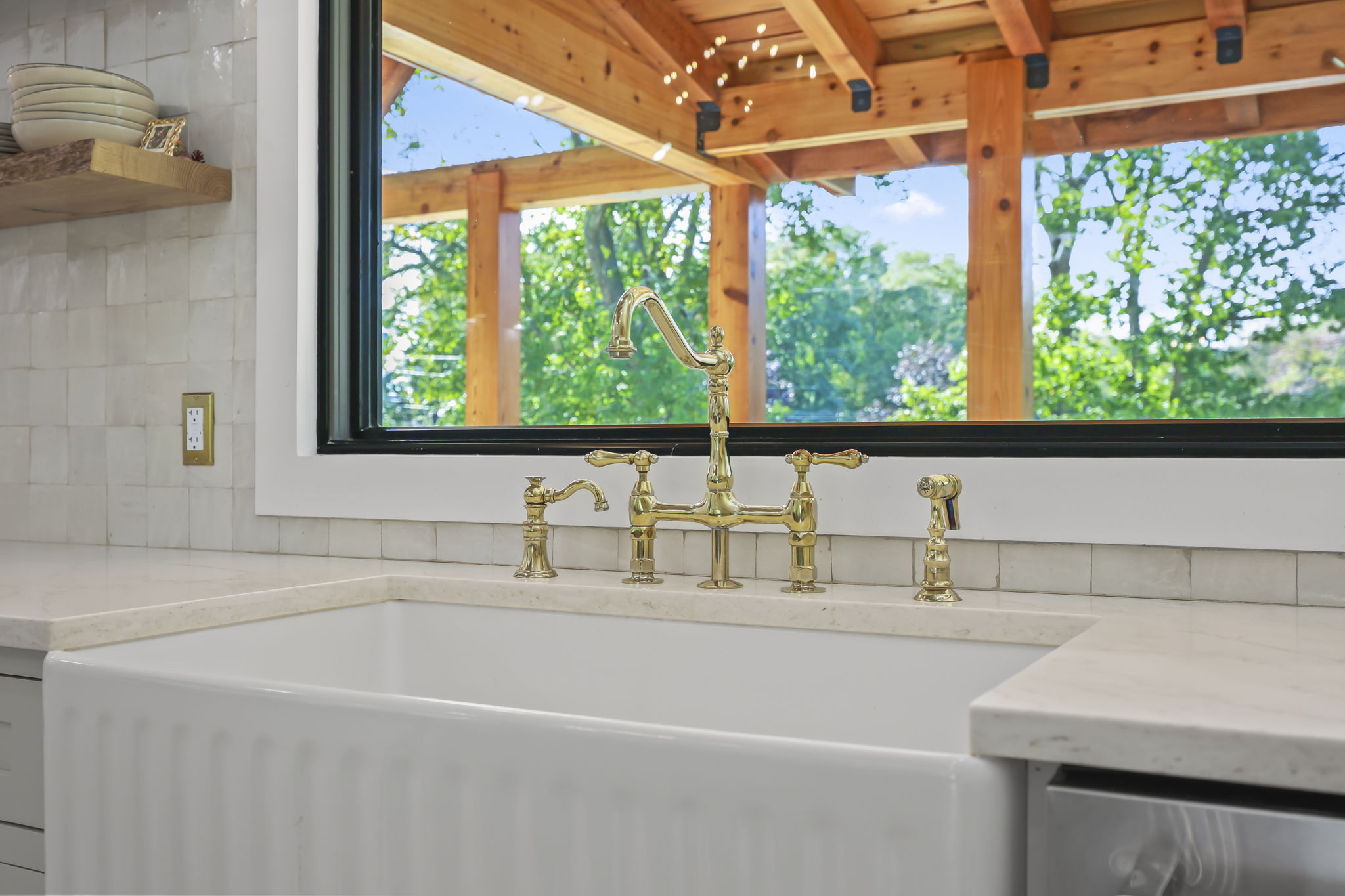 Farmhouse sink with brass bridge faucet